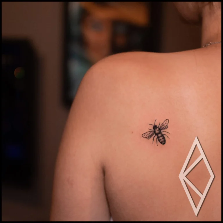 Bee tattoo, small tattoo on woman's back