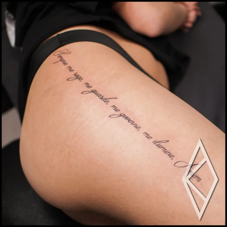 Script tattoo on woman's thigh