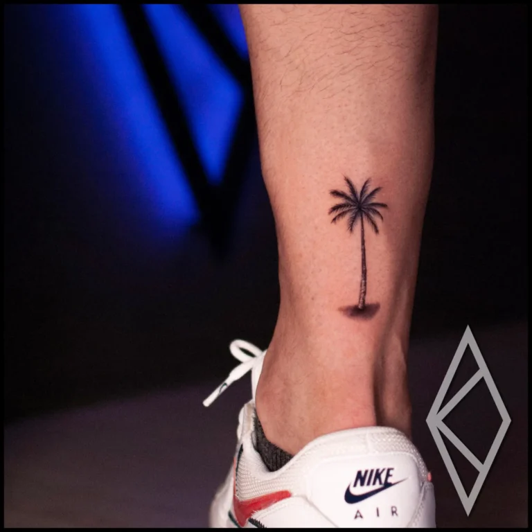 Small palm tree tattoo on lower leg